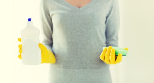 Staff member using PPE during a cleaning task
